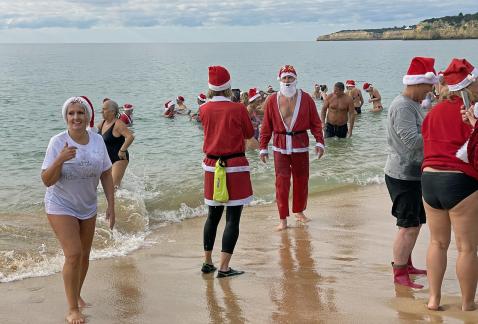 Santa Clauses are swimming