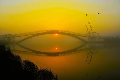 the sunrise of a bicycle bridge 03