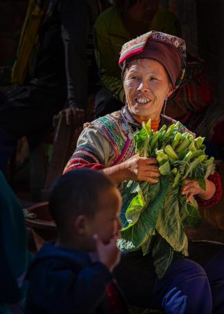An old lady selling vegetables