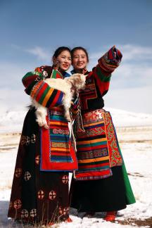 Tibetan girl holding lamb
