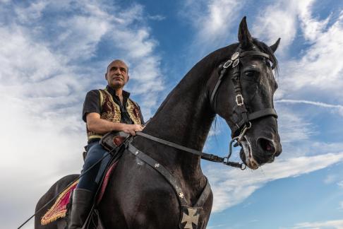 MAN RIDING HORSE