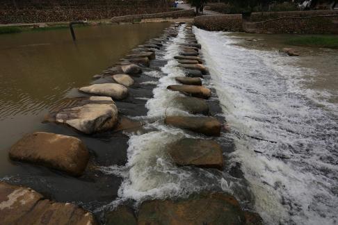 White waves chasing stones 1