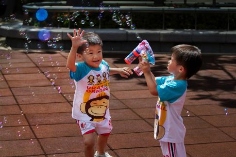 Boys playing bubbles