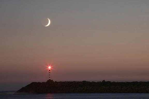 Moonset and the lighthouse